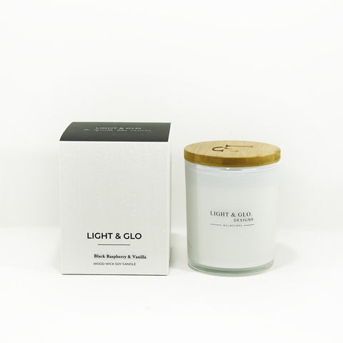 Raspberry and vanilla fragrance candle in white glass